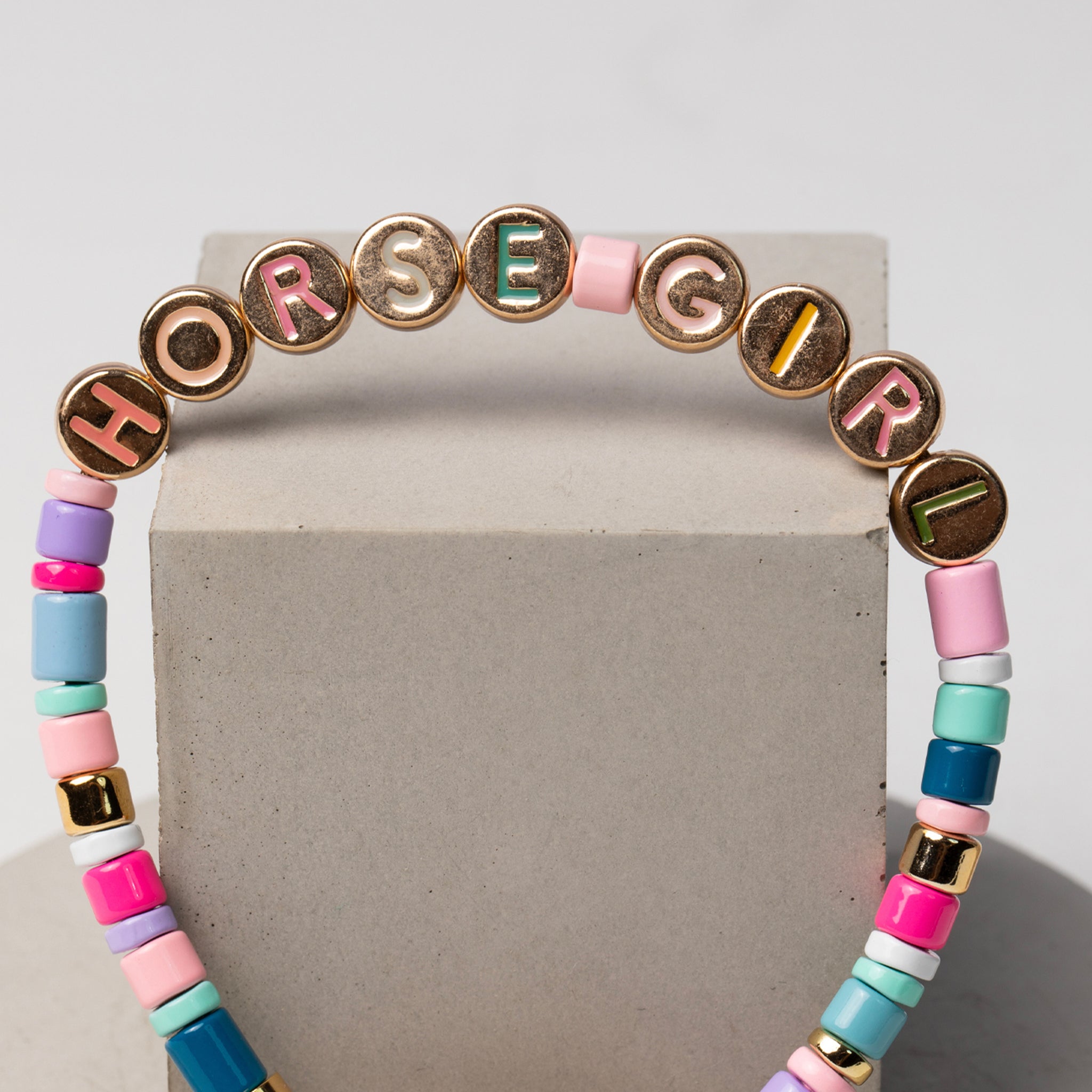 Gold bracelet with multiple linked horseshoe charms, a beautiful and symbolic piece of horse jewelry and a top present idea for horse lovers.