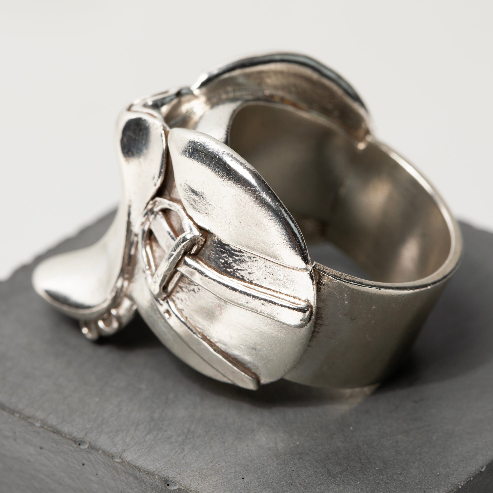 A bold sterling silver ring shaped like a horse sit, a unique piece of horse jewelry for women's rings.