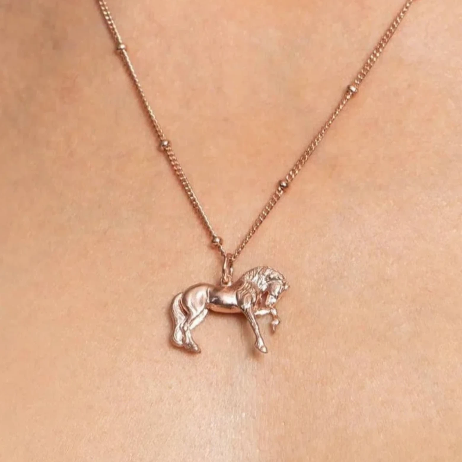 A detailed shot of a Rose Gold Pendant, a charming pendant necklace with a horse.