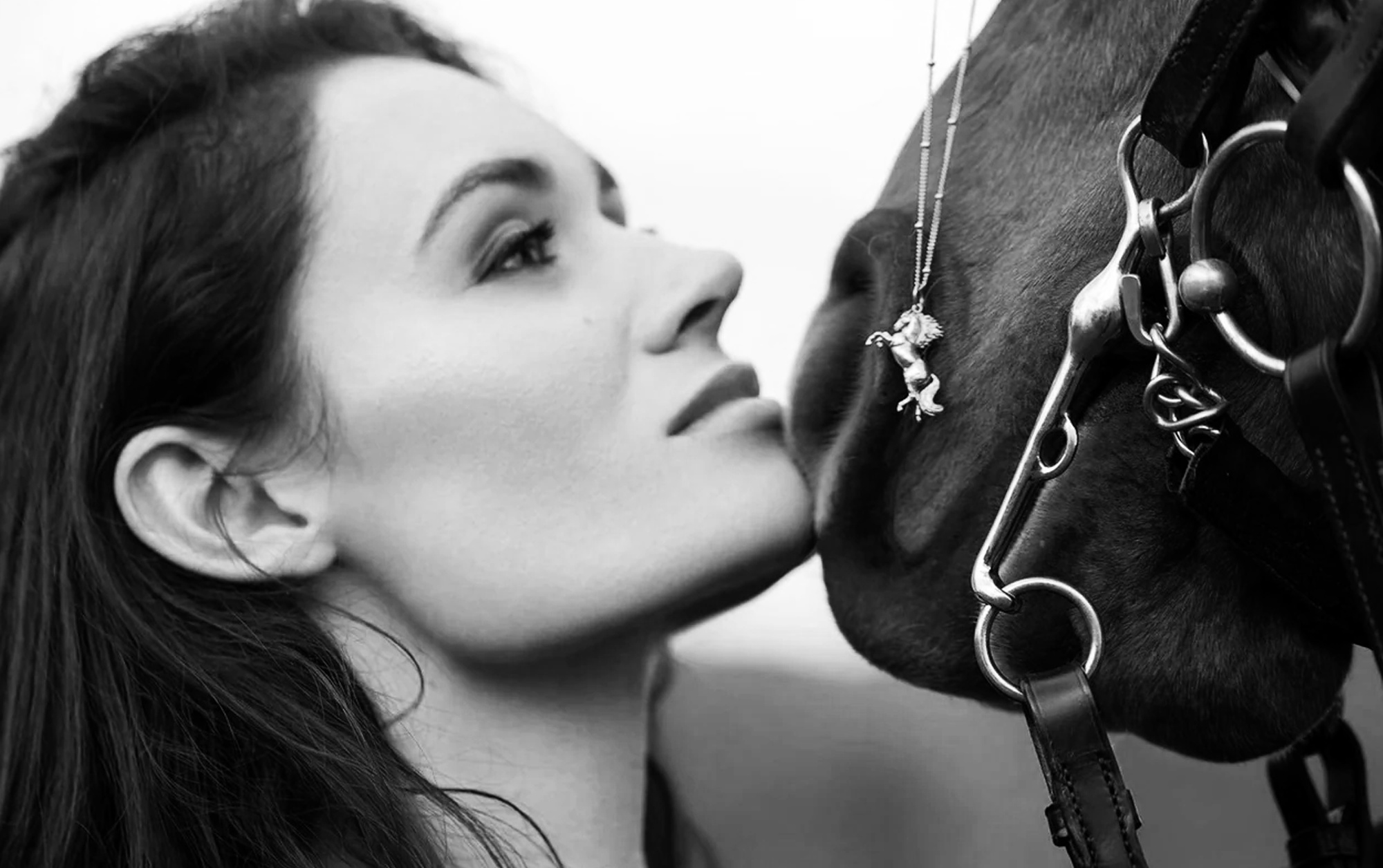 A woman and a horse, symbolizing the bond between them with an elegant piece of horse jewelry.