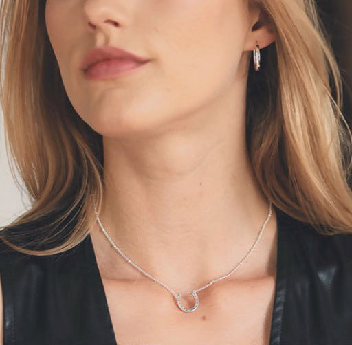 A silver Snaffle Bit Necklace is perfect for horse enthusiasts, it adds a refined touch to any outfit and makes a memorable equestrian gifts for women and horse themed gifts, embodying sophistication in its design.  Ideal  for horse lovers, fans of equestrian inspired jewelry, horseback riders,  silver horse jewelry. 