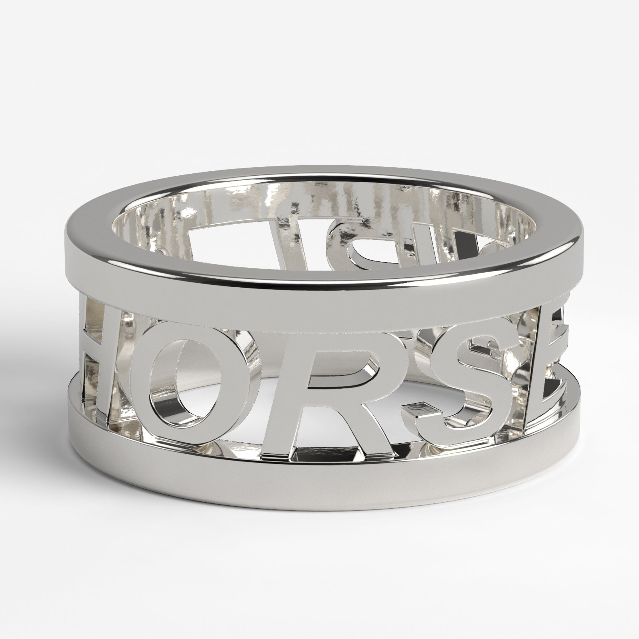 Side view of a wide, polished silver ring with the word "HORSE" cut out around the band, representing the 'Horse Girl Silver Ring'